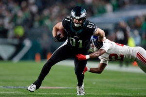 PHILADELPHIA, PENNSYLVANIA - DECEMBER 25: Grant Calcaterra #81 of the Philadelphia Eagles avoids a tackle against Adoree' Jackson #22 of the New York Giants during the first quarter at Lincoln Financial Field on December 25, 2023 in Philadelphia, Pennsylvania.