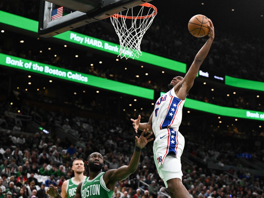 BOSTON, MASSACHUSETTS - DECEMBER 25: Tyrese Maxey #0 of the Philadelphia 76ers attempts a basket against Jaylen Brown #7 of the Boston Celtics during the second quarter at the the TD Garden on December 25, 2024 in Boston, Massachusetts