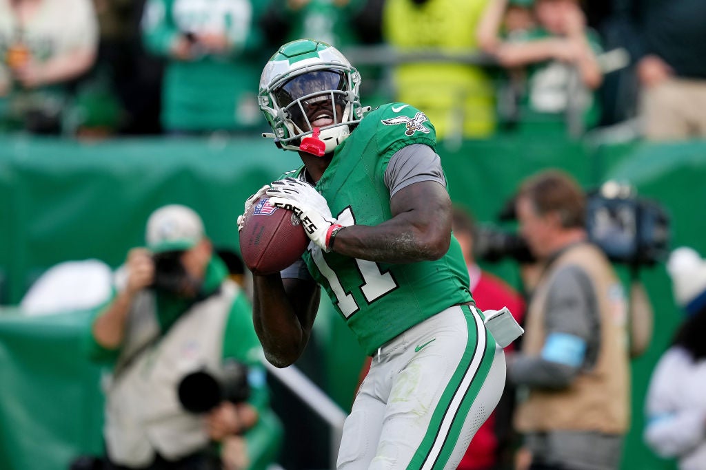 PHILADELPHIA, PENNSYLVANIA - DECEMBER 29: A.J. Brown #11 of the Philadelphia Eagles throws the ball in the stands after catching a touchdown against the Dallas Cowboys during the third quarter at Lincoln Financial Field on December 29, 2024 in Philadelphia, Pennsylvania.