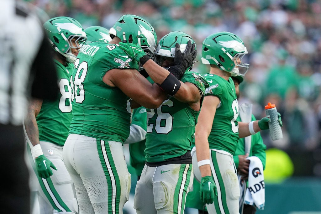 PHILADELPHIA, PENNSYLVANIA - DECEMBER 29: Saquon Barkley #26 of the Philadelphia Eagles celebrates with teammate Jordan Mailata #68 after running the ball against the Dallas Cowboys during the fourth quarter at Lincoln Financial Field on December 29, 2024 in Philadelphia, Pennsylvania.