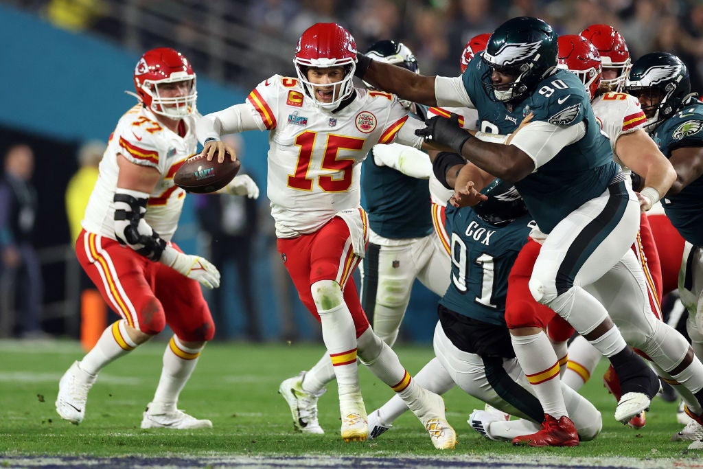 Patrick Mahomes #15 of the Kansas City Chiefs scrambles away from Jordan Davis #90 of the Philadelphia Eagles during the third quarter in Super Bowl LVII at State Farm Stadium on February 12, 2023 in Glendale, Arizona.