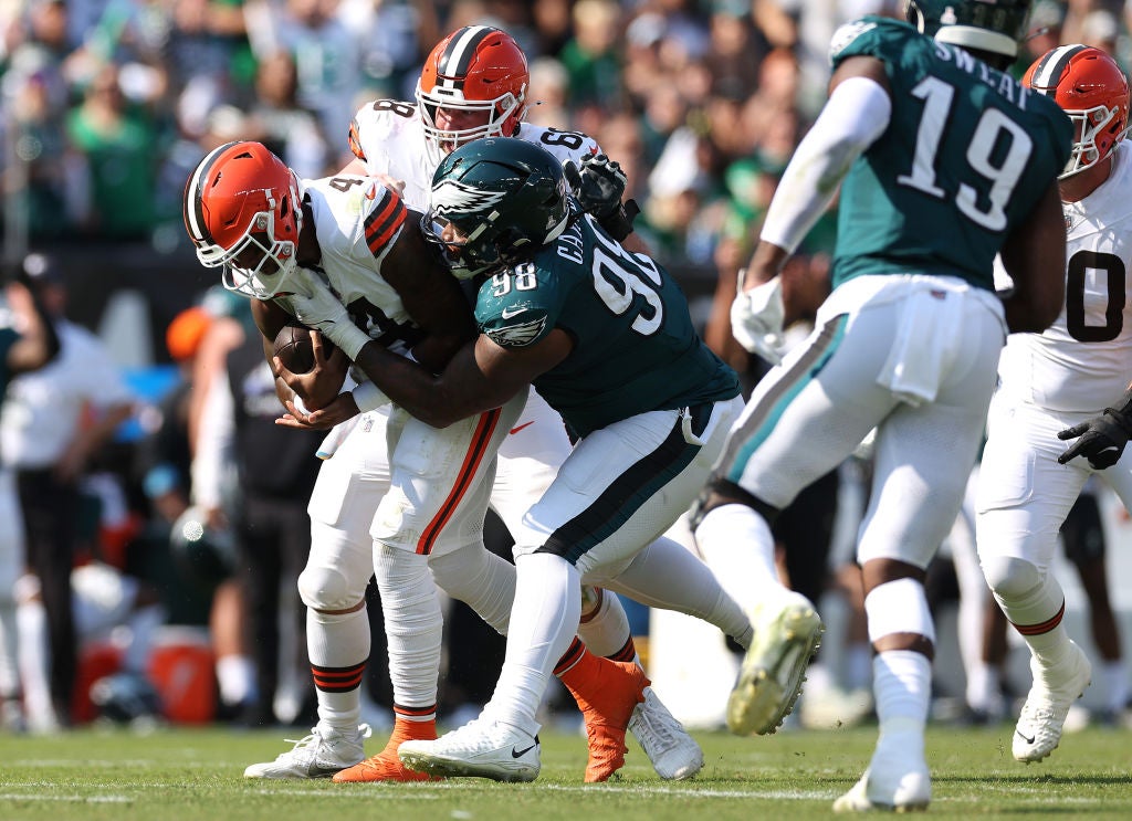 PHILADELPHIA, PENNSYLVANIA - OCTOBER 13: Jalen Carter #98 of the Philadelphia Eagles tackles Deshaun Watson #4 of the Cleveland Browns on fourth down during the second quarter at Lincoln Financial Field on October 13, 2024 in Philadelphia, Pennsylvania.