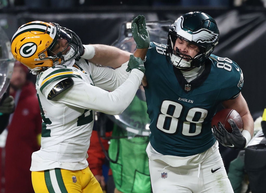 PHILADELPHIA, PENNSYLVANIA - JANUARY 12: Dallas Goedert #88 of the Philadelphia Eagles stiff arms Carrington Valentine #24 of the Green Bay Packers before scoring a third quarter touchdown during the NFC Wild Card Playoff at Lincoln Financial Field on January 12, 2025 in Philadelphia, Pennsylvania.