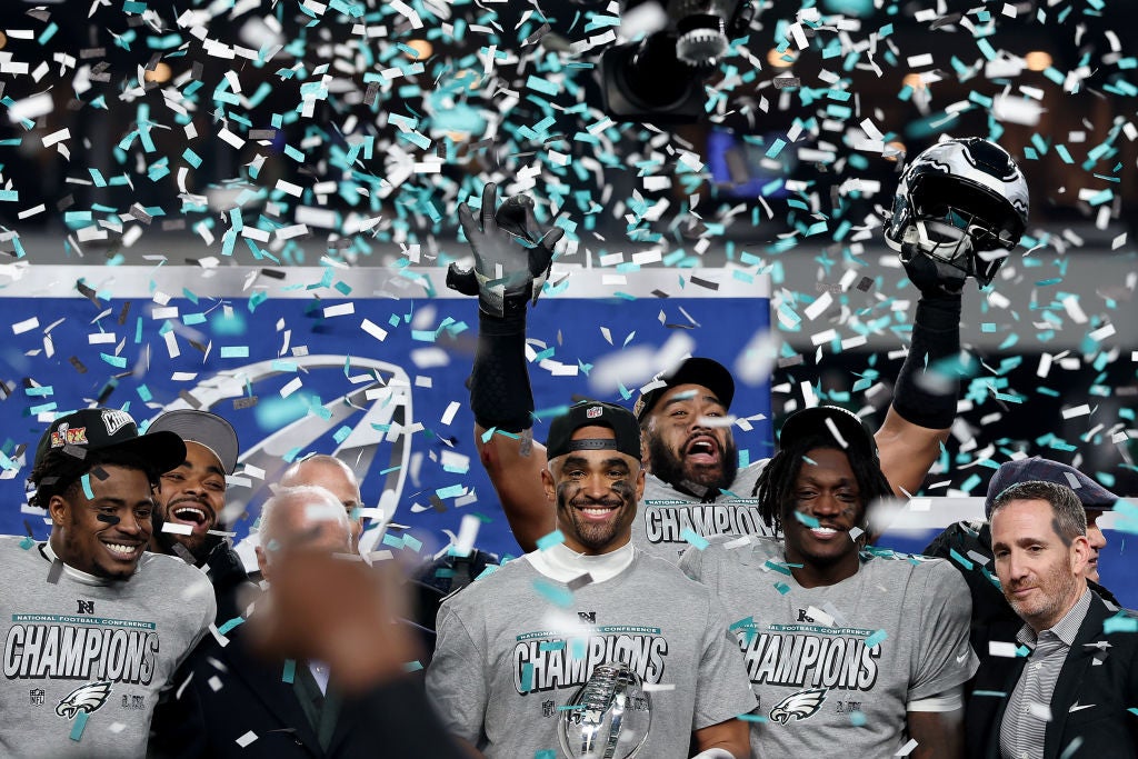 PHILADELPHIA, PENNSYLVANIA - JANUARY 26: Jalen Hurts #1 of the Philadelphia Eagles and teammates celebrate during the trophy ceremony after their 55-23 win against the Washington Commanders during the NFC Championship Game at Lincoln Financial Field on January 26, 2025 in Philadelphia, Pennsylvania.