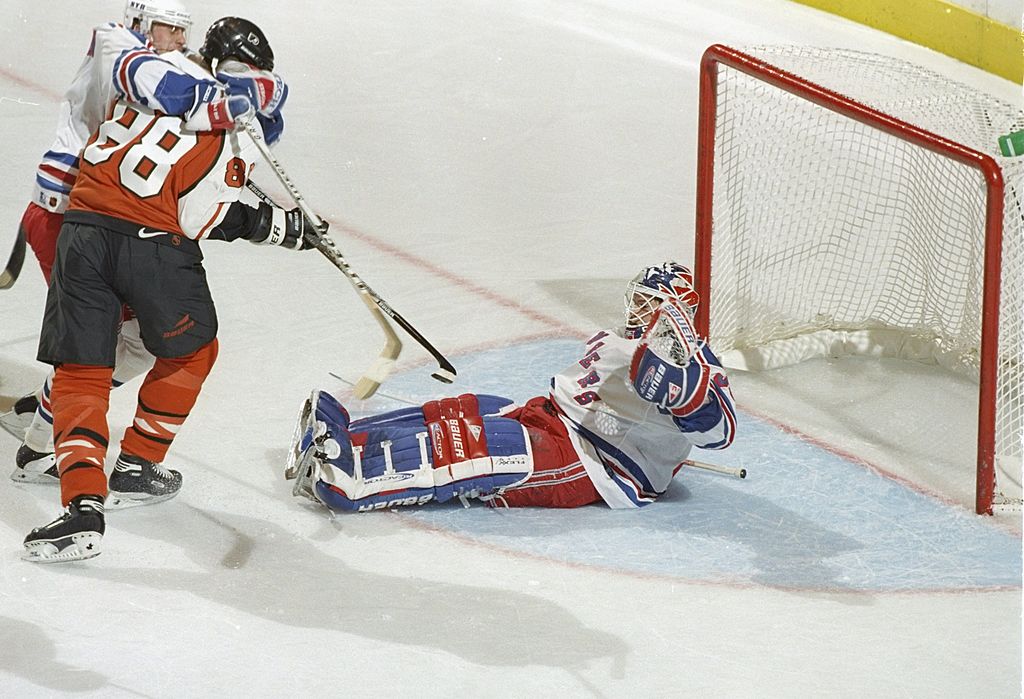 23 May 1997: Center Eric Lindros of the Philadelphia Flyers (center) attempts to score on New York Rangers goaltender Mike Richter during a playoff game at Madison Square Garden in New York City, New York. The Flyers won the game, 3-2.