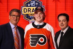 Oliver Bonk poses with Keith Jones and Danny Briere after being drafted in the 2023 NHL Draft