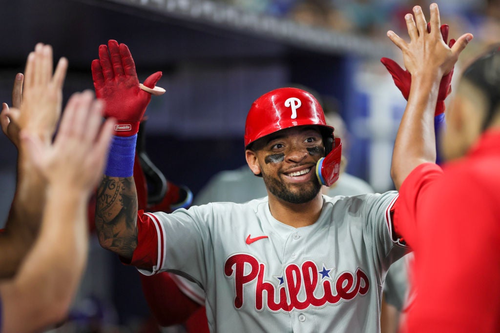 MIAMI, FLORIDA - JULY 9: Edmundo Sosa #33 of the Philadelphia Phillies celebrates with teammates after hitting a two-run home run against the Miami Marlins during the fifth inning at loanDepot park on July 9, 2023 in Miami, Florida.