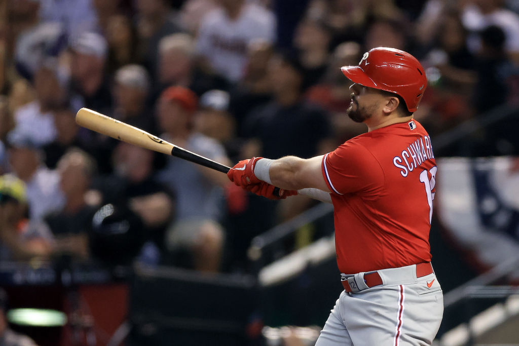 PHOENIX, ARIZONA - OCTOBER 21: Kyle Schwarber #12 of the Philadelphia Phillies hits a solo home run against Zac Gallen #23 of the Arizona Diamondbacks during the sixth inning in Game Five of the National League Championship Series at Chase Field on October 21, 2023 in Phoenix, Arizona.