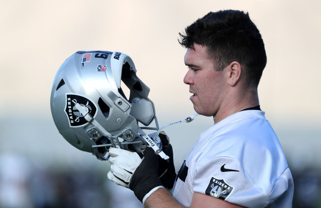 HENDERSON, NEVADA - JULY 28: Jimmy Morrissey #65 of the Las Vegas Raiders adjusts his helmet during training camp at the Las Vegas Raiders Headquarters/Intermountain Healthcare Performance Center on July 28, 2021 in Henderson, Nevada.
