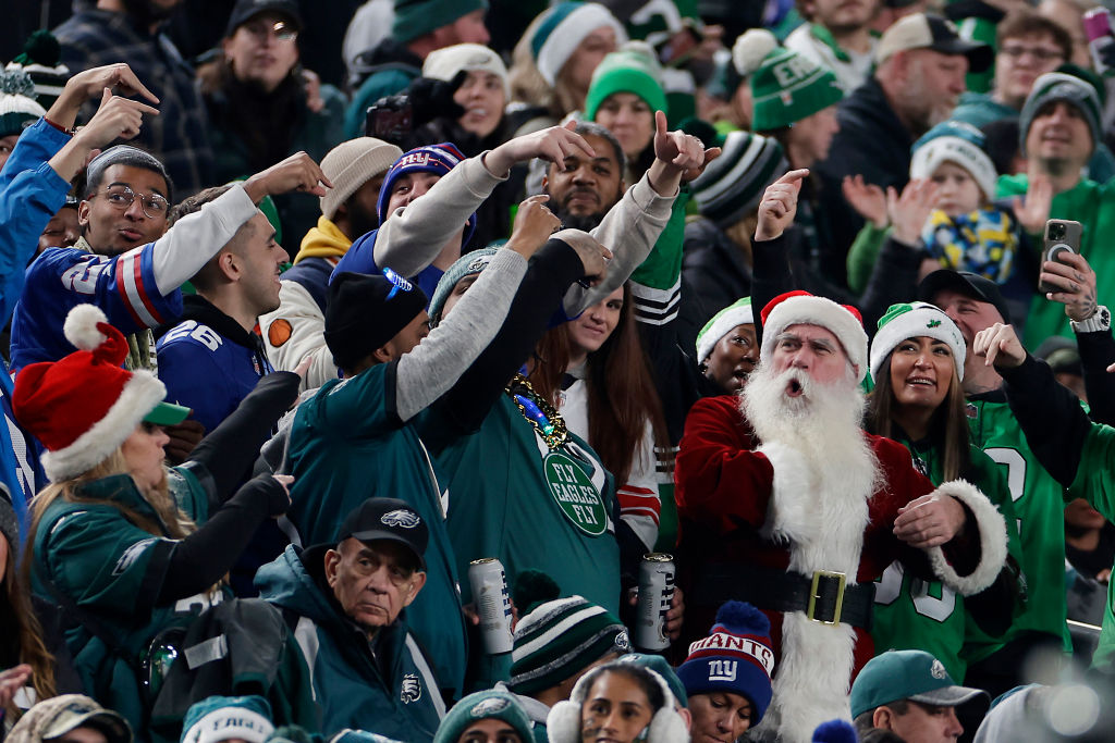 PHILADELPHIA, PENNSYLVANIA - DECEMBER 25: Philadelphia Eagles fans point to a fan dressed as Santa during the game against the New York Giants at Lincoln Financial Field on December 25, 2023 in Philadelphia, Pennsylvania.