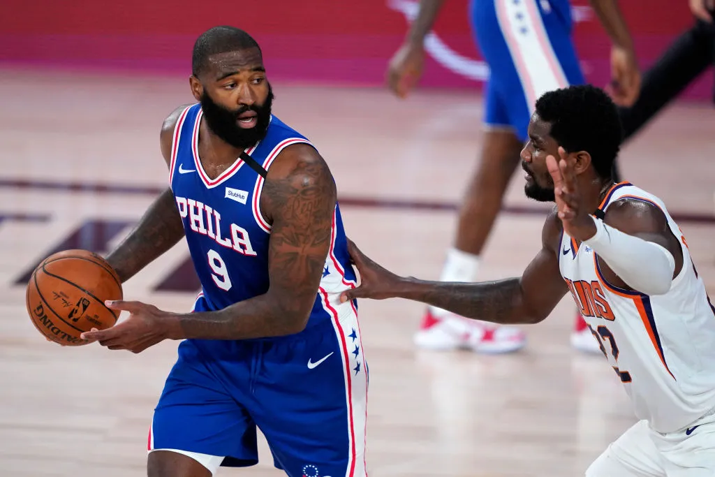LAKE BUENA VISTA, FLORIDA - AUGUST 11:  Kyle O'Quinn #9 of the Philadelphia 76ers looks for help as Deandre Ayton #22 of the Phoenix Suns defends during the first half of a NBA basketball game at Visa Athletic Center at ESPN Wide World Of Sports Complex on August 11, 2020 in Lake Buena Vista, Florida.  