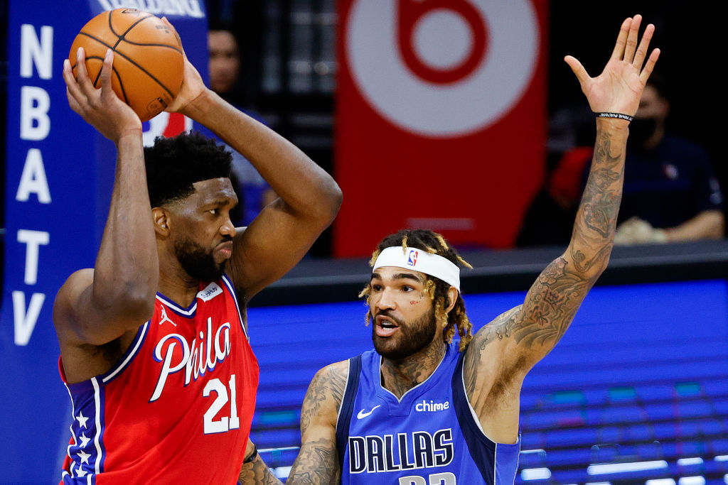 PHILADELPHIA, PENNSYLVANIA - FEBRUARY 25: Joel Embiid #21 of the Philadelphia 76ers looks to pass over Willie Cauley-Stein #33 of the Dallas Mavericks at Wells Fargo Center on February 25, 2021 in Philadelphia, Pennsylvania.