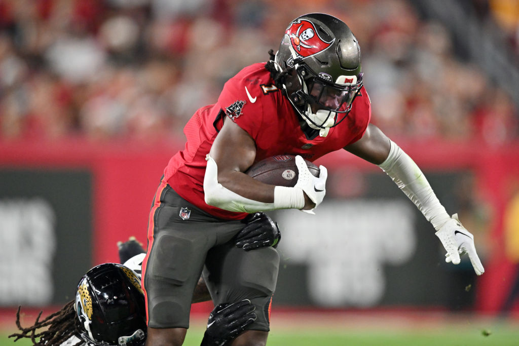 TAMPA, FLORIDA - DECEMBER 24:  Rachaad White #1 of the Tampa Bay Buccaneers carries the ball against the Jacksonville Jaguars during the third quarter at Raymond James Stadium on December 24, 2023 in Tampa, Florida. 