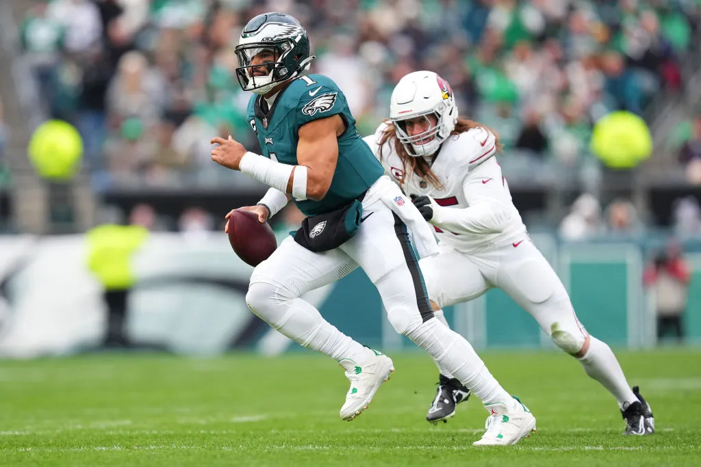 PHILADELPHIA, PENNSYLVANIA - DECEMBER 31: Jalen Hurts #1 of the Philadelphia Eagles runs with the ball against Dennis Gardeck #45 of the Arizona Cardinals during the second quarter at Lincoln Financial Field on December 31, 2023 in Philadelphia, Pennsylvania. 