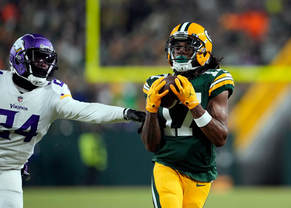 GREEN BAY, WISCONSIN - JANUARY 02: Wide receiver Davante Adams #17 of the Green Bay Packers catches a pass for a first down as cornerback Mackensie Alexander #24 of the Minnesota Vikings defends during the 1st quarter of the game at Lambeau Field on January 02, 2022 in Green Bay, Wisconsin. 