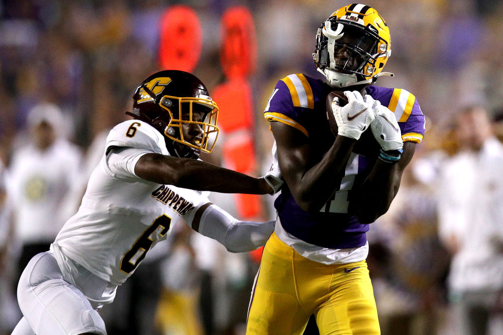 Brian Thomas Jr. #11 of the LSU Tigers catches a pass over Daedae Hill #6 of the Central Michigan Chippewas during the second quarter at Tiger Stadium