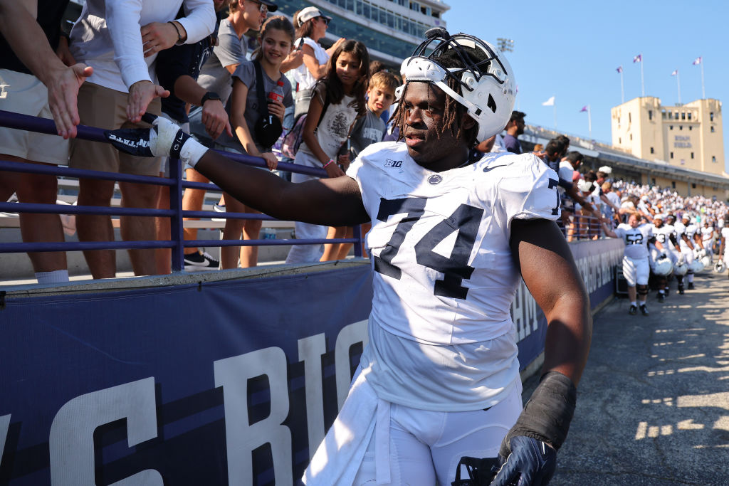  Olumuyiwa Fashanu #74 of the Penn State Nittany Lions high fives fans after defeating the Northwestern Wildcats at Ryan Field