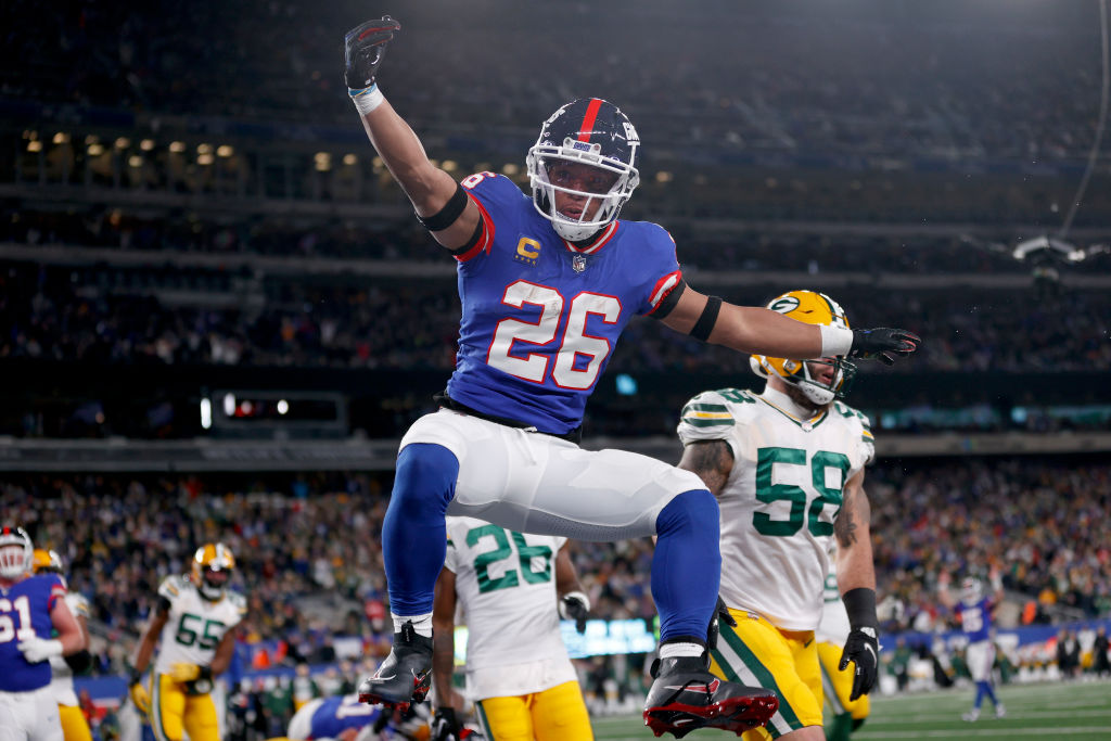 EAST RUTHERFORD, NEW JERSEY - DECEMBER 11: Saquon Barkley #26 of the New York Giants celebrates after scoring a five yard touchdown against the Green Bay Packers during the second quarter in the game at MetLife Stadium on December 11, 2023 in East Rutherford, New Jersey.
