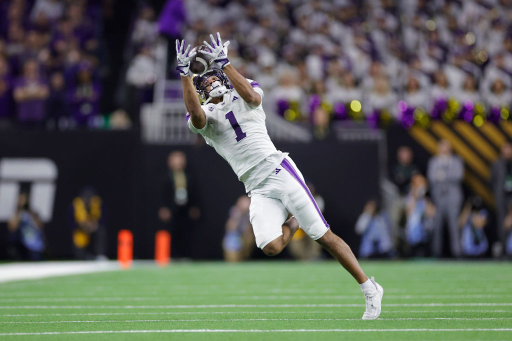 Rome Odunze #1 of the Washington Huskies catches a pass that was called back due to a holding call in the fourth quarter against the Michigan Wolverines during the 2024 CFP National Championship game at NRG Stadium 
