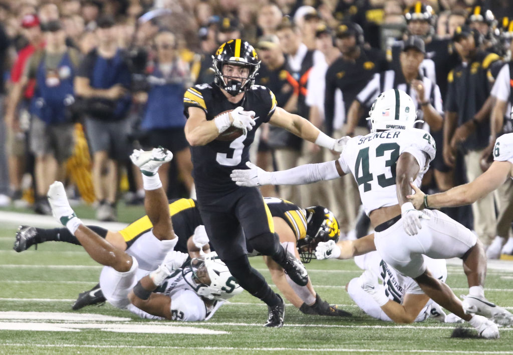 IOWA CITY, IOWA- SEPTEMBER 30: Defensive back Cooper DeJean #3 of the Iowa Hawkeyes runs back a punt return during the second half breaking a tackle by defensive back Malik Spencer #43 the Michigan State Spartans at Kinnick Stadium on September 30, 2023 in Iowa City, Iowa.