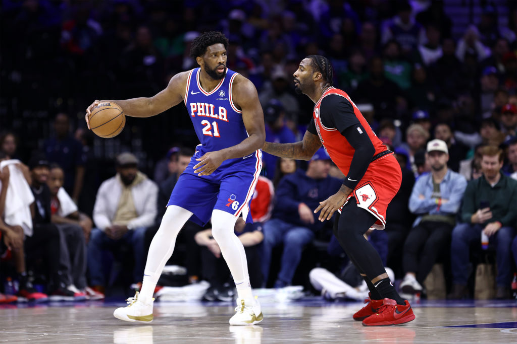 PHILADELPHIA, PENNSYLVANIA - DECEMBER 18: Joel Embiid #21 of the Philadelphia 76ers dribbles by Andre Drummond #3 of the Chicago Bulls at the Wells Fargo Center on December 18, 2023 in Philadelphia, Pennsylvania. 