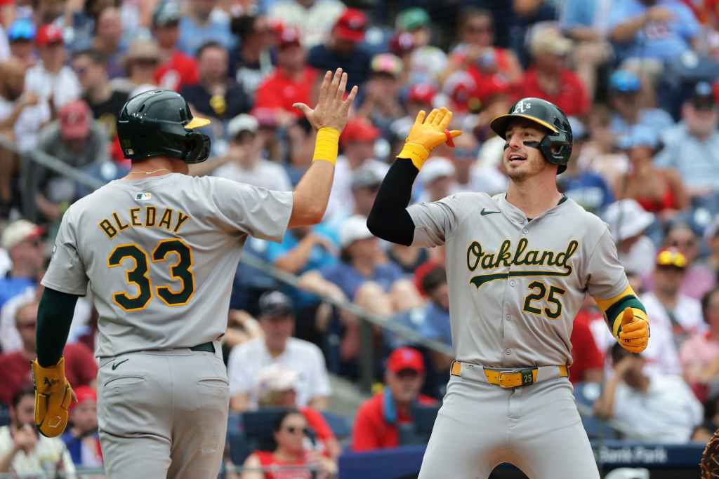 Brent Rooker #25 of the Oakland Athletics celebrates with teammate JJ Bleday #33 after hitting a two-run home run in the sixth inning during a game against the Philadelphia Phillies at Citizens Bank Park on July 14, 2024 in Philadelphia, Pennsylvania. Oakland won 18-3