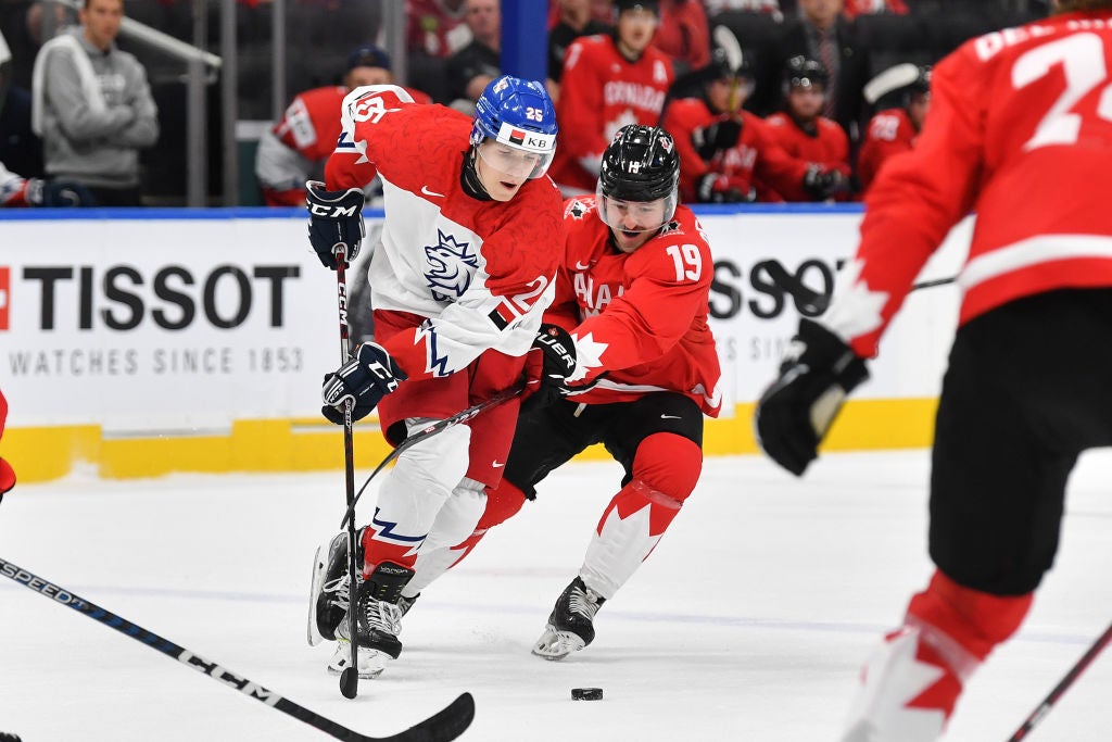 Elliot Desnoyers #19 of Canada battles for the puck against Jiri Kulich #25 of Czechia in the IIHF World Junior Championship on August 19, 2022 at Rogers Place in Edmonton, Alberta, Canada