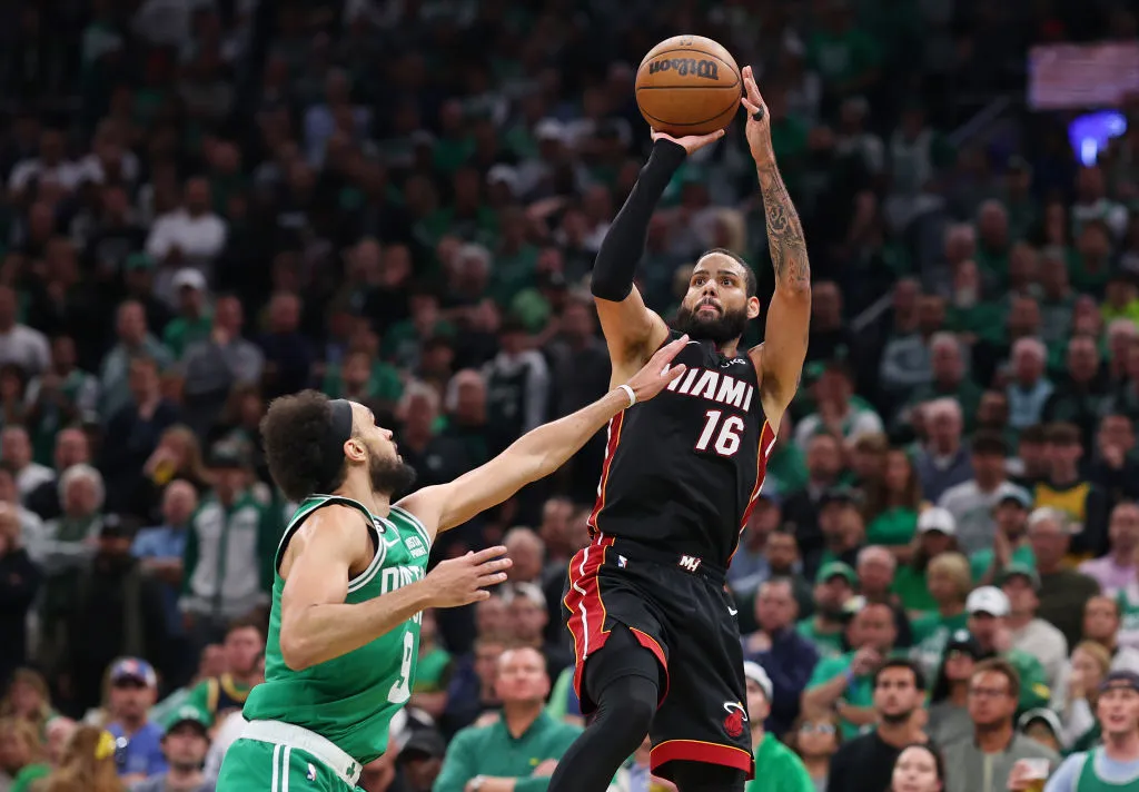 BOSTON, MASSACHUSETTS - MAY 29: Caleb Martin #16 of the Miami Heat attempts a three point basket against Derrick White #9 of the Boston Celtics during the third quarter in game seven of the Eastern Conference Finals at TD Garden on May 29, 2023 in Boston, Massachusetts. 