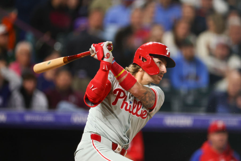 DENVER, COLORADO - MAY 25: Bryson Stott #5 of the Philadelphia Phillies singles in the fifth inning during the game against the Colorado Rockies at Coors Field on May 25, 2024 in Denver, Colorado. 