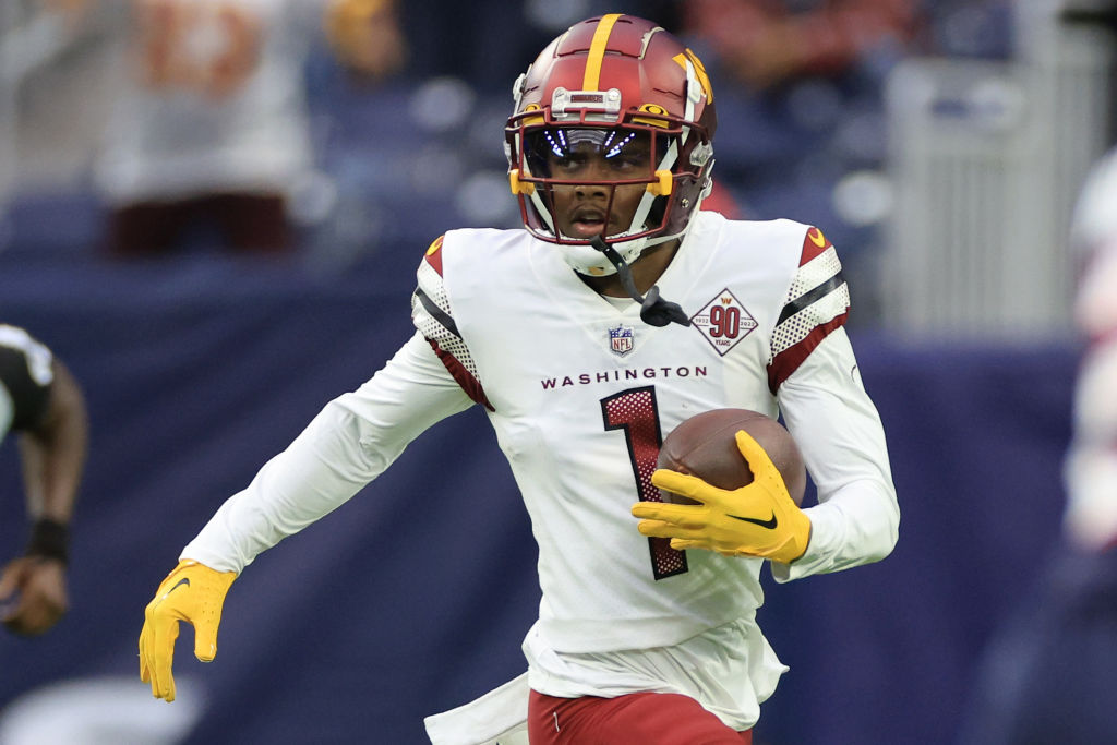 HOUSTON, TEXAS - NOVEMBER 20: Jahan Dotson #1 of the Washington Commanders runs with the ball in the first quarter of a game against the Houston Texans at NRG Stadium on November 20, 2022 in Houston, Texas.