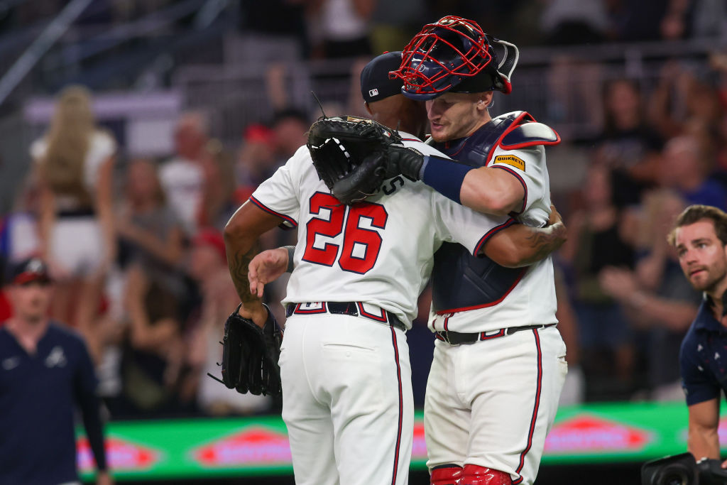 Raisel Iglesias #26 and Sean Murphy #12 of the Atlanta Braves celebrate after a victory over the Philadelphia Phillies in the eighth inning at Truist Park on August 20, 2024 in Atlanta, Georgia.