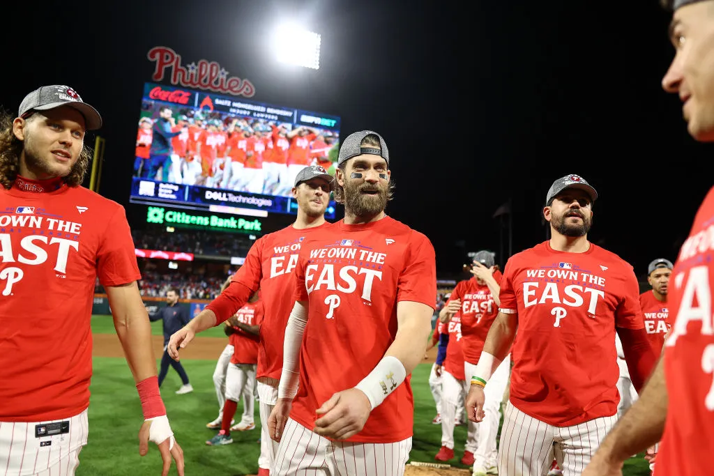 PHILADELPHIA, PENNSYLVANIA - SEPTEMBER 23: Bryce Harper #3 of the Philadelphia Phillies reacts with teammates after the Philadelphia Phillies clinch the 2024 NL East Division at Citizens Bank Park on September 23, 2024 in Philadelphia, Pennsylvania.