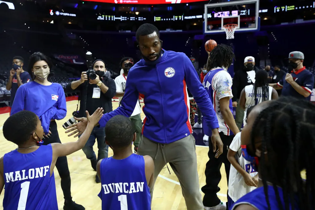 Meek Mill (C) greets fans during a charity event before a game between the Philadelphia 76ers and the Miami Heat at Wells Fargo Center on December 15, 2021 in Philadelphia, Pennsylvania. NOTE TO USER: User expressly acknowledges and agrees that, by downloading and or using this photograph, User is consenting to the terms and conditions of the Getty Images License Agreement.