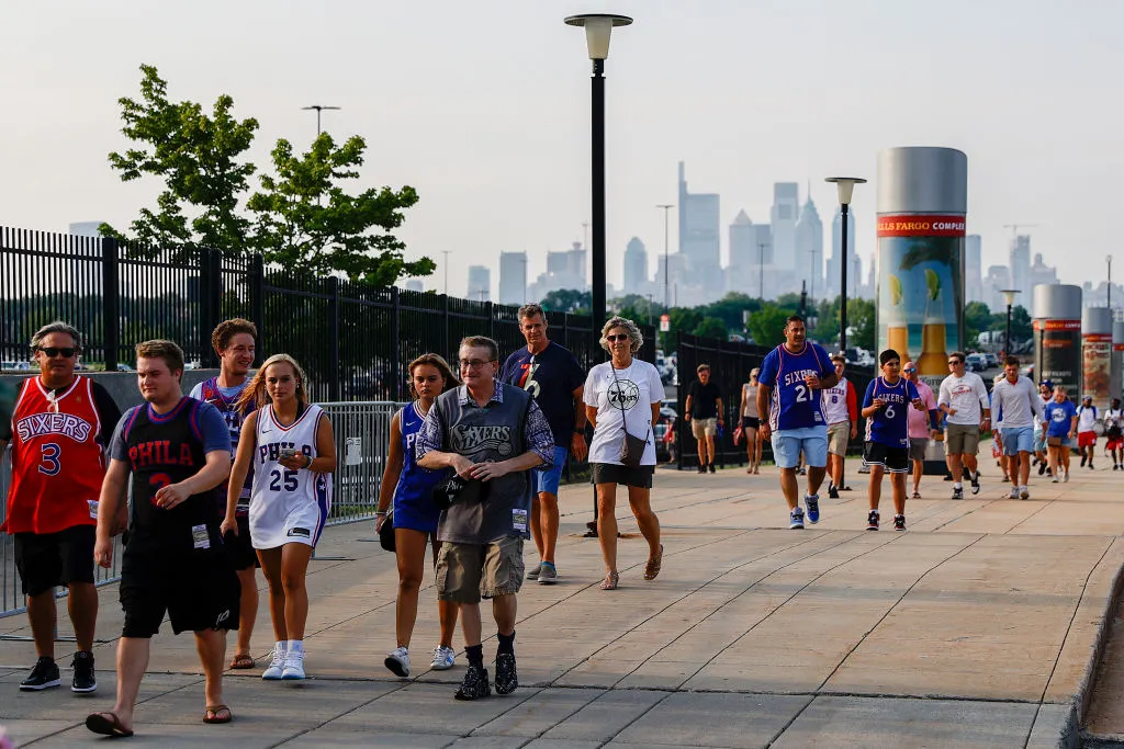 Fans walk to Wells Fargo Center before Game Seven of the Eastern Conference Semifinals between the Philadelphia 76ers and the Atlanta Hawks at Wells Fargo Center on June 20, 2021 in Philadelphia, Pennsylvania. NOTE TO USER: User expressly acknowledges and agrees that, by downloading and or using this photograph, User is consenting to the terms and conditions of the Getty Images License Agreement.