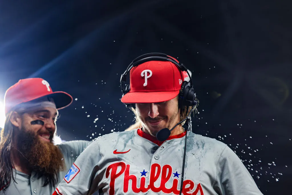 Brandon Marsh #16 throws water on Bryson Stott #5 of the Philadelphia Phillies following a game against the Miami Marlins at loanDepot park on September 05, 2024 in Miami, Florida.