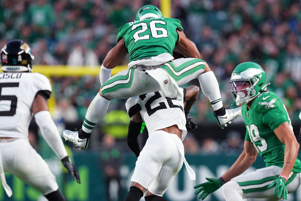 PHILADELPHIA, PENNSYLVANIA - NOVEMBER 03: Saquon Barkley #26 of the Philadelphia Eagles hurdles Jarrian Jones #22 of the Jacksonville Jaguars in the second quarter of a game at Lincoln Financial Field on November 03, 2024 in Philadelphia, Pennsylvania.