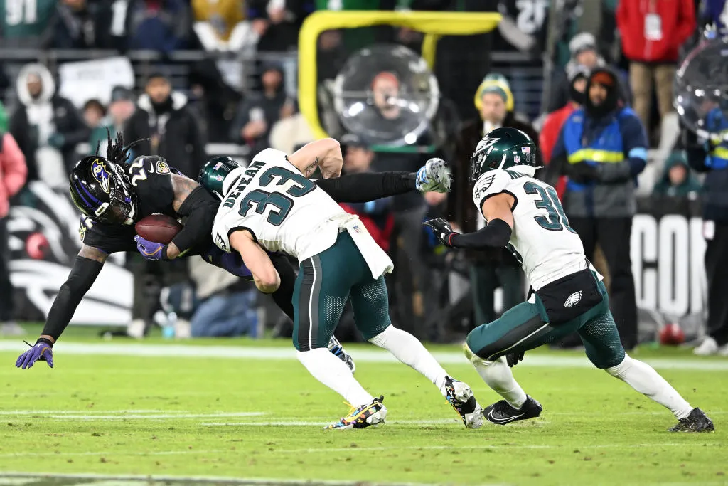 BALTIMORE, MARYLAND - DECEMBER 01: Derrick Henry #22 of the Baltimore Ravens is tackled by Cooper DeJean #33 of the Philadelphia Eagles during the fourth quarter at M&T Bank Stadium on December 01, 2024 in Baltimore, Maryland. Philadelphia defeated Baltimore 24-19.