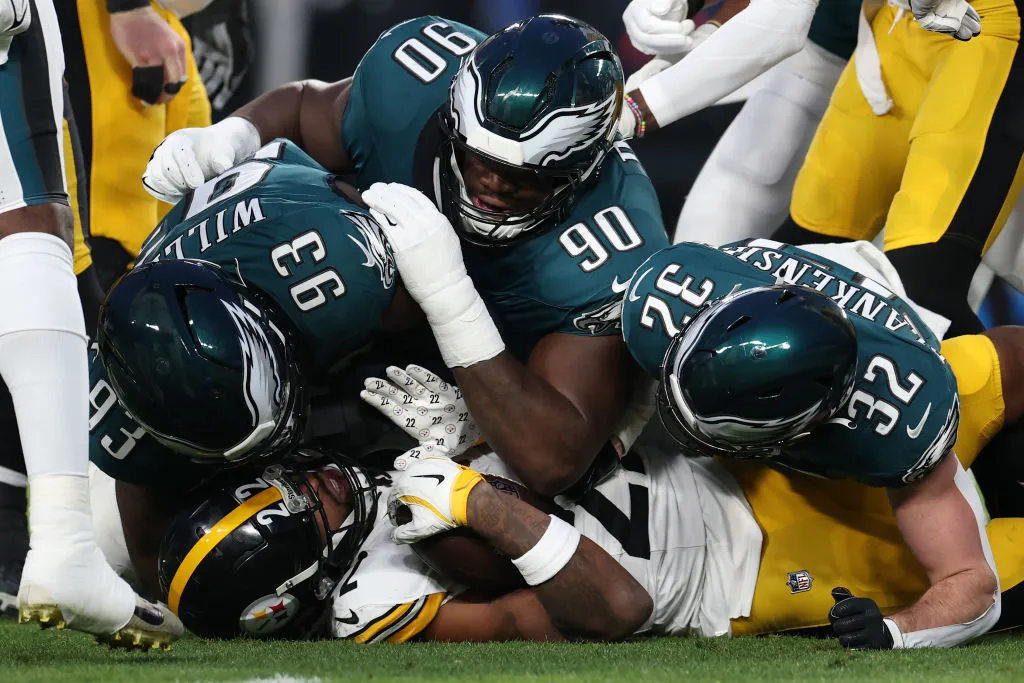 Najee Harris #22 of the Pittsburgh Steelers is tackled by Milton Williams #93, Jordan Davis #90, and Reed Blankenship #32 during the first quarter at Lincoln Financial Field on December 15, 2024 in Philadelphia, Pennsylvania.