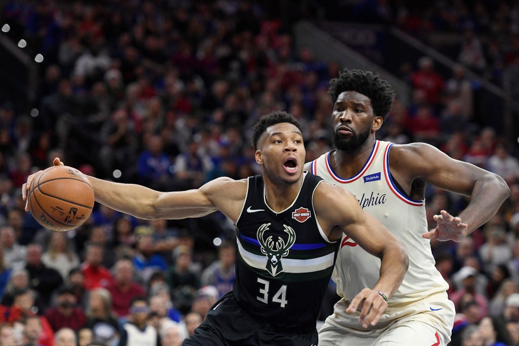 Giannis Antetokounmpo #34 of the Milwaukee Bucks looks to pass as Joel Embiid #21 of the Philadelphia 76ers defends during the first half of the game at Wells Fargo Center on December 25, 2019 in Philadelphia, Pennsylvania. NOTE TO USER: User expressly acknowledges and agrees that, by downloading and or using this photograph, User is consenting to the terms and conditions of the Getty Images License Agreement.